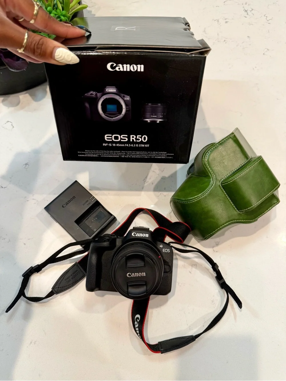 Canon EOS R50 Black Mirrorless Camera with Black Strap and Green Case